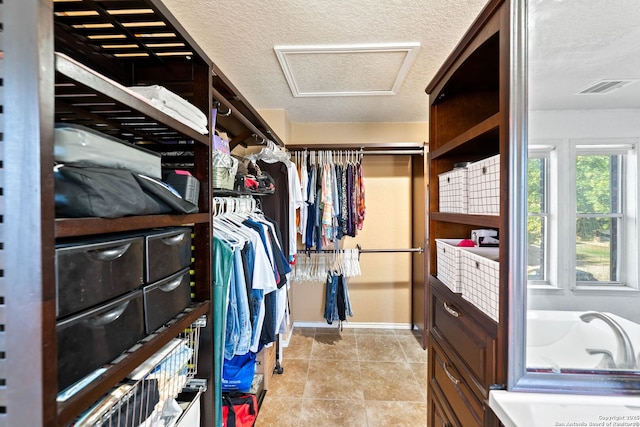9014 Camino Rey, San Antonio, TX 78245 - walk in closet featuring attic access and light tile patterned floors