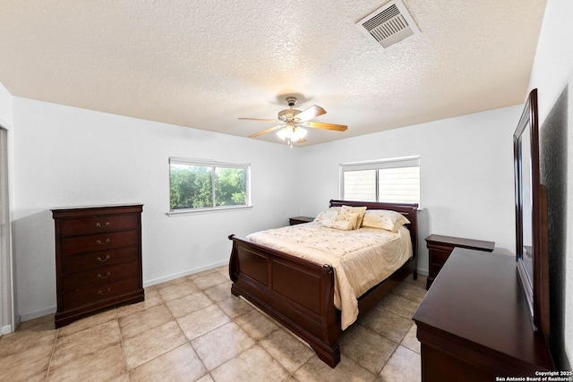 9014 Camino Rey, San Antonio, TX 78245 - bedroom with a textured ceiling, a ceiling fan, and baseboards