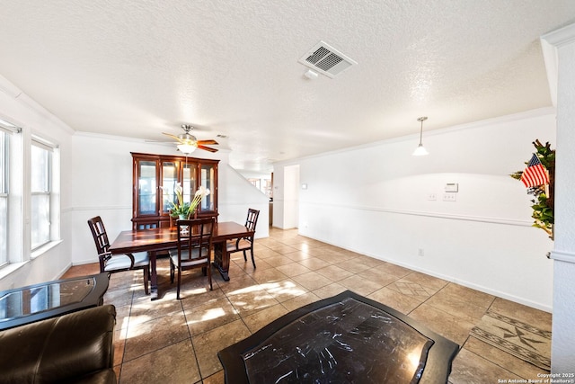 9014 Camino Rey, San Antonio, TX 78245 - dining area with ornamental molding, tile patterned floors, a ceiling fan, and baseboards