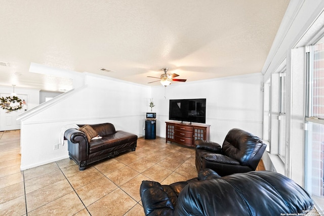 9014 Camino Rey, San Antonio, TX 78245 - living area with light tile patterned flooring, a ceiling fan, and a textured ceiling