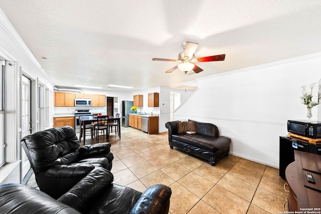 9014 Camino Rey, San Antonio, TX 78245 - living area with a textured ceiling, crown molding, light tile patterned floors, a ceiling fan, and baseboards