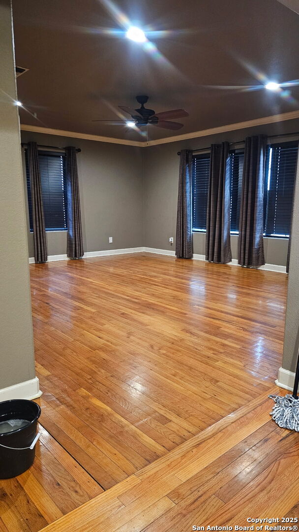 218 E Antonio, Uvalde, TX 78801 - spare room with light wood-type flooring, ceiling fan, and baseboards