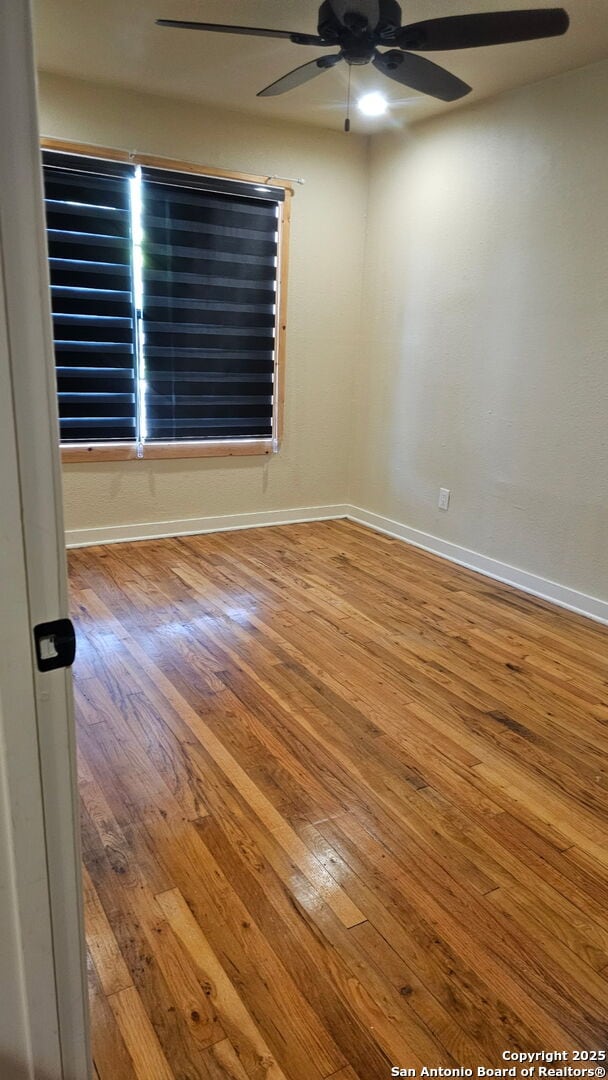 218 E Antonio, Uvalde, TX 78801 - unfurnished room with hardwood / wood-style flooring, a ceiling fan, and baseboards