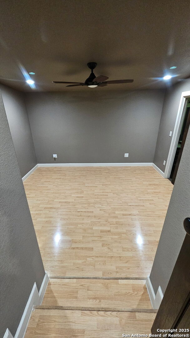 218 E Antonio, Uvalde, TX 78801 - spare room with a ceiling fan, wood finished floors, and baseboards