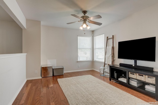 6039 Woodway Ct, San Antonio, TX 78249 - living area with ceiling fan, wood finished floors, and baseboards