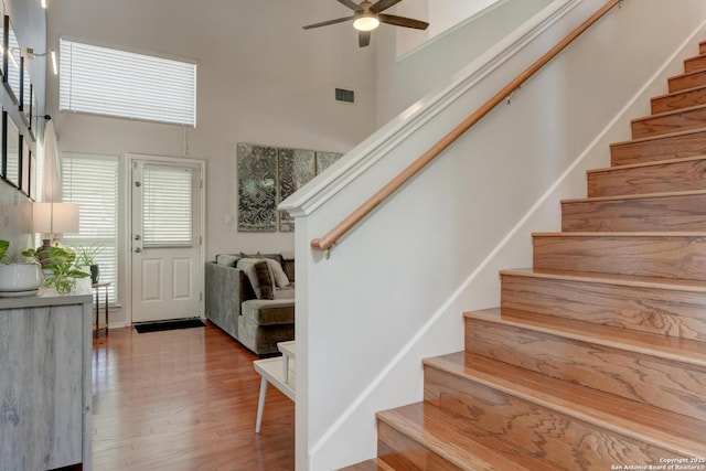 6039 Woodway Ct, San Antonio, TX 78249 - stairs featuring a high ceiling, wood finished floors, and a ceiling fan