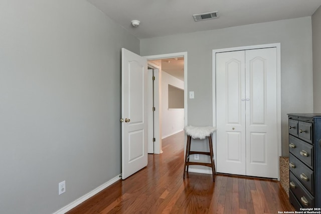6039 Woodway Ct, San Antonio, TX 78249 - bedroom featuring wood finished floors, a closet, and baseboards