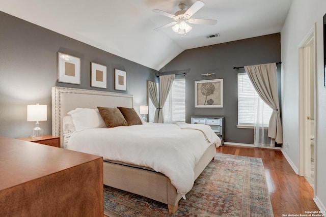 6039 Woodway Ct, San Antonio, TX 78249 - bedroom featuring multiple windows, lofted ceiling, wood finished floors, baseboards, and a ceiling fan