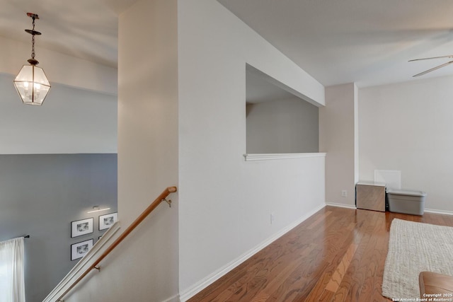 6039 Woodway Ct, San Antonio, TX 78249 - hallway featuring wood finished floors, baseboards, and an upstairs landing
