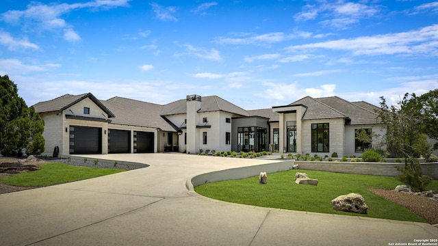 121 Greystone Pt, Boerne, TX 78006 - view of front of house featuring a front yard, a garage, concrete driveway, stone siding, and a tile roof