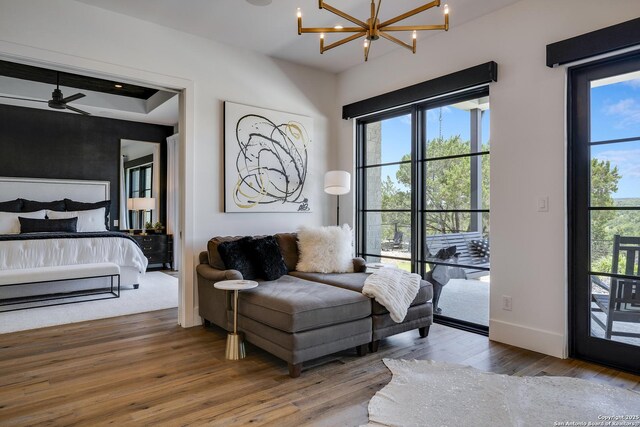 121 Greystone Pt, Boerne, TX 78006 - bedroom with hardwood / wood-style floors, a chandelier, access to outside, and baseboards