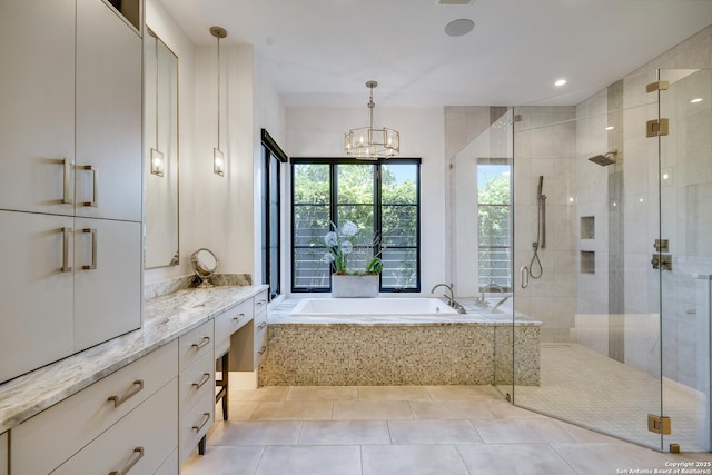 121 Greystone Pt, Boerne, TX 78006 - full bath with a bath, a shower stall, vanity, a chandelier, and tile patterned flooring