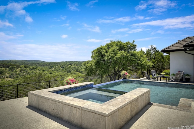 121 Greystone Pt, Boerne, TX 78006 - view of swimming pool with a view of trees, a patio, and a pool with connected hot tub