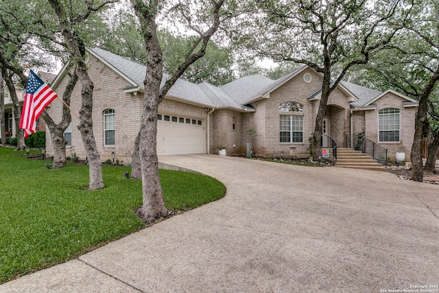 18210 Crystal Ridge Dr, San Antonio, TX 78259 - view of front of home with brick siding, concrete driveway, a garage, a shingled roof, and a front lawn