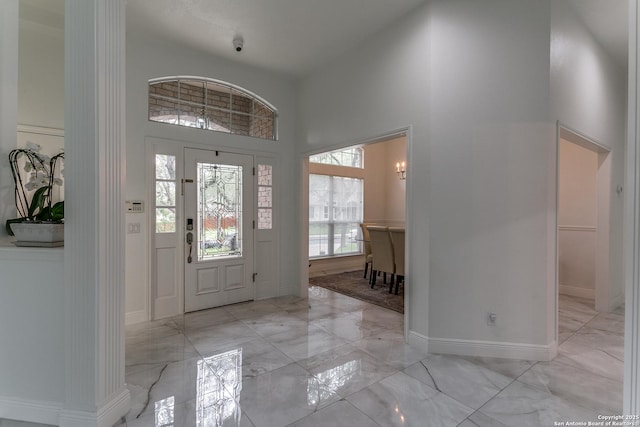 18210 Crystal Ridge Dr, San Antonio, TX 78259 - entrance foyer featuring light marble finish floors, a high ceiling, and baseboards