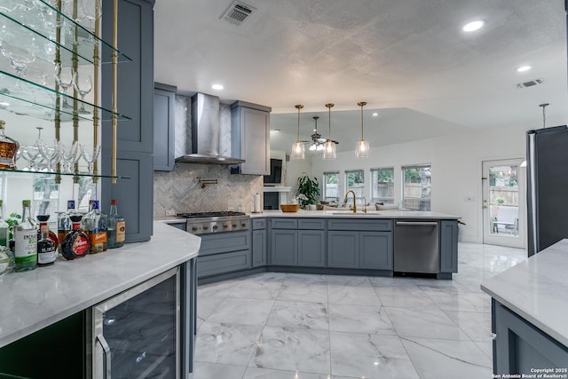 18210 Crystal Ridge Dr, San Antonio, TX 78259 - kitchen with stainless steel appliances, beverage cooler, a sink, wall chimney exhaust hood, and a peninsula