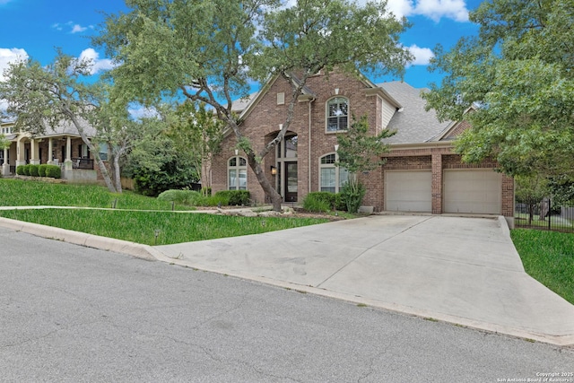 27711 Woodway Bnd, Boerne, TX 78006 - view of front facade with brick siding, an attached garage, concrete driveway, and a front lawn