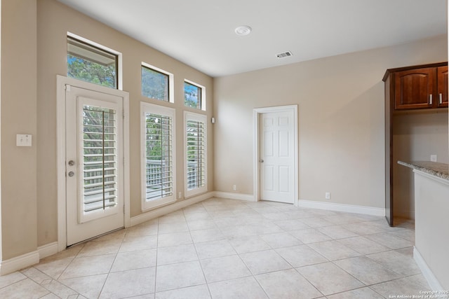 27711 Woodway Bnd, Boerne, TX 78006 - unfurnished dining area with light tile patterned floors and baseboards