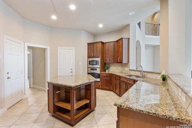 27711 Woodway Bnd, Boerne, TX 78006 - kitchen featuring stainless steel appliances, open shelves, light stone countertops, tasteful backsplash, and light tile patterned floors