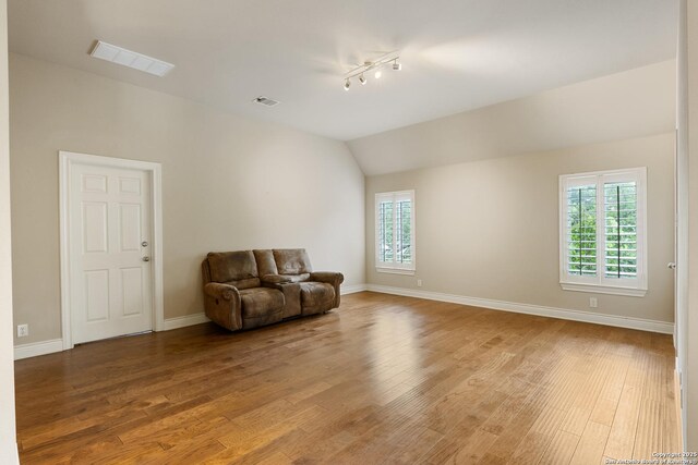 27711 Woodway Bnd, Boerne, TX 78006 - sitting room with light wood-style floors, lofted ceiling, and track lighting