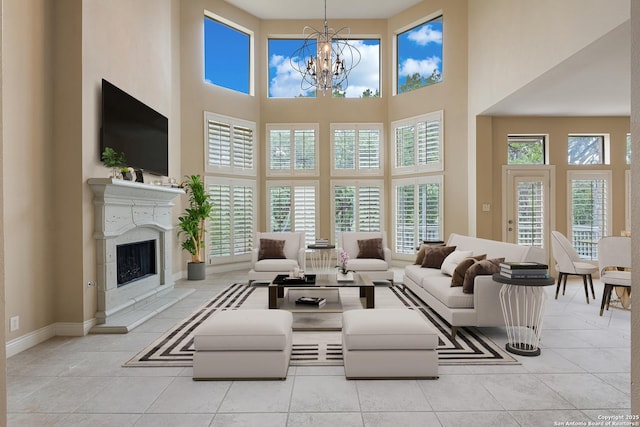 27711 Woodway Bnd, Boerne, TX 78006 - living area featuring tile patterned flooring, a chandelier, a towering ceiling, and a premium fireplace