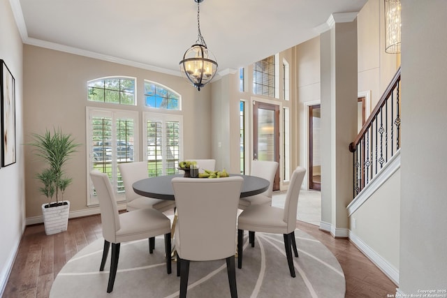 27711 Woodway Bnd, Boerne, TX 78006 - dining area featuring a chandelier, crown molding, wood finished floors, and stairway