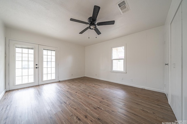 2310 W Houston St, San Antonio, TX 78207 - empty room featuring french doors, wood finished floors, a textured ceiling, a ceiling fan, and baseboards