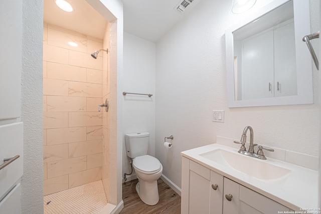 2310 W Houston St, San Antonio, TX 78207 - full bath with toilet, vanity, a shower stall, and wood finished floors