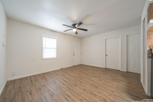 2310 W Houston St, San Antonio, TX 78207 - unfurnished bedroom featuring light wood finished floors, baseboards, and ceiling fan