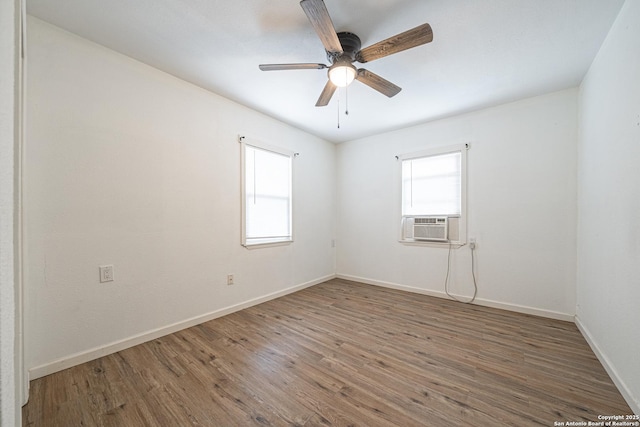 2310 W Houston St, San Antonio, TX 78207 - empty room with healthy amount of natural light, wood finished floors, baseboards, and ceiling fan