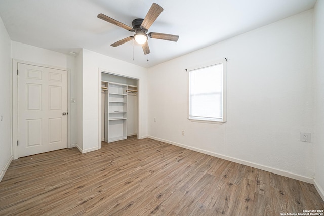 2310 W Houston St, San Antonio, TX 78207 - unfurnished bedroom featuring wood finished floors, baseboards, a closet, and ceiling fan