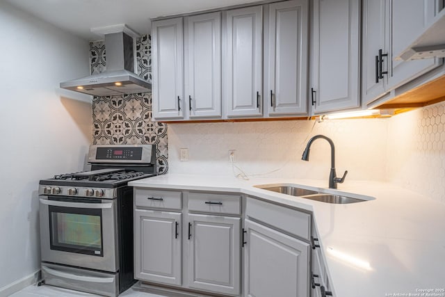 2310 W Houston St, San Antonio, TX 78207 - kitchen with gas range, wall chimney exhaust hood, a sink, and decorative backsplash