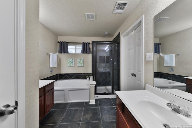 5327 Gemsbuck Chase, San Antonio, TX 78251 - bathroom with vanity, a bath, a textured ceiling, a shower stall, and tile patterned flooring