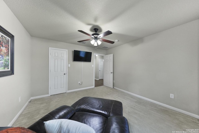 5327 Gemsbuck Chase, San Antonio, TX 78251 - carpeted living room featuring ceiling fan, baseboards, and a textured ceiling