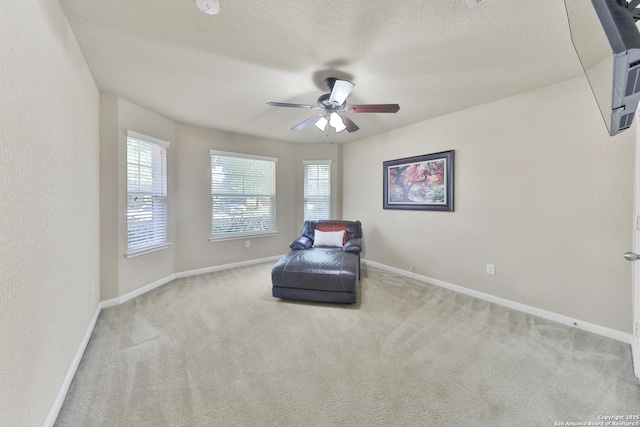 5327 Gemsbuck Chase, San Antonio, TX 78251 - sitting room with a ceiling fan, carpet flooring, baseboards, and a textured ceiling