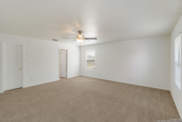 9423 Maraval Crk, San Antonio, TX 78245 - spare room featuring ceiling fan, light colored carpet, and baseboards