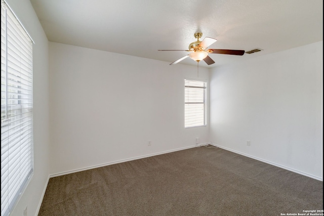 9423 Maraval Crk, San Antonio, TX 78245 - empty room with a ceiling fan, dark colored carpet, and baseboards