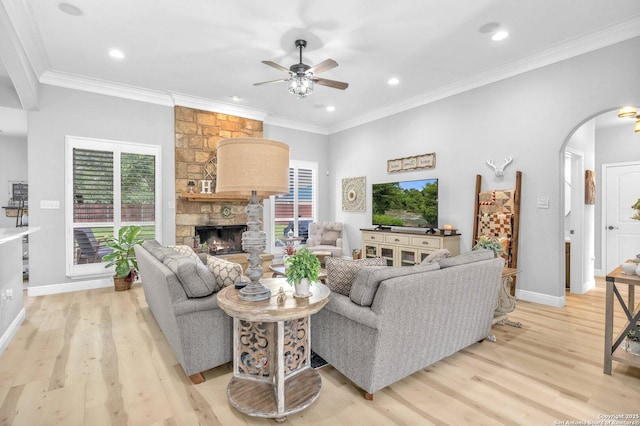 1216 Windy Dawn, Seguin, TX 78155 - living area with arched walkways, ceiling fan, light wood-style floors, a fireplace, and crown molding