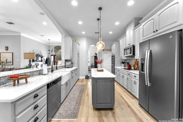 1216 Windy Dawn, Seguin, TX 78155 - kitchen with appliances with stainless steel finishes, gray cabinetry, a peninsula, a kitchen island, and recessed lighting