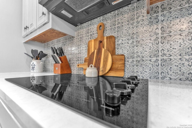 1216 Windy Dawn, Seguin, TX 78155 - kitchen view of decorative backsplash, black electric stovetop, and white cabinets