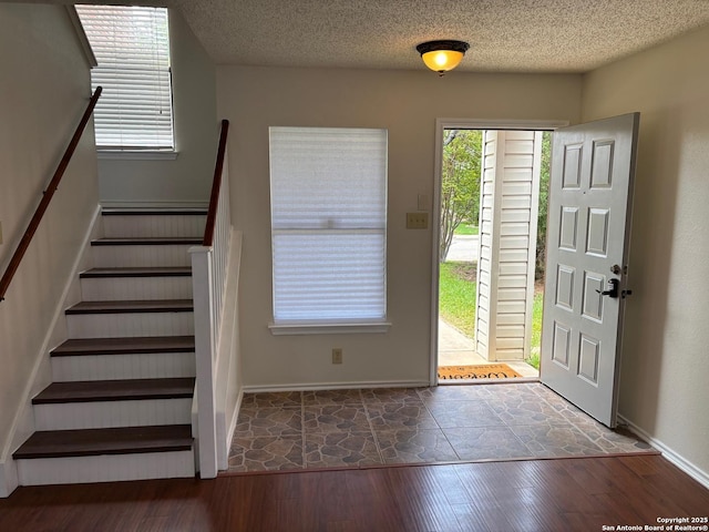 7835 Ruby Mdw, San Antonio, TX 78251 - foyer entrance featuring wood finished floors, stairs, baseboards, and a textured ceiling