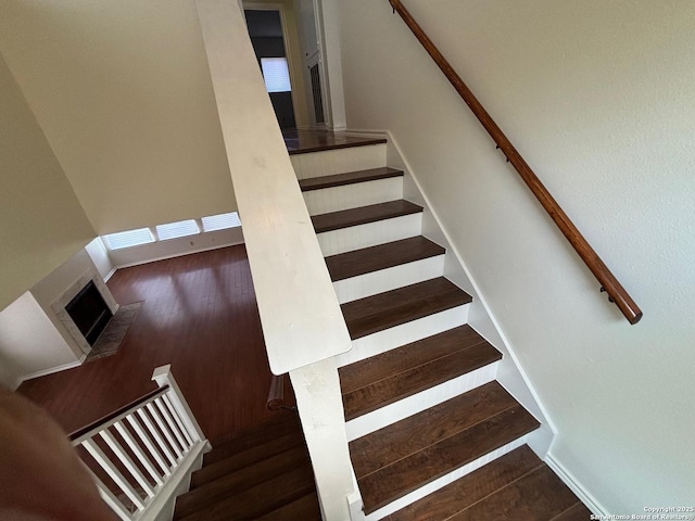 7835 Ruby Mdw, San Antonio, TX 78251 - staircase with wood finished floors and a fireplace