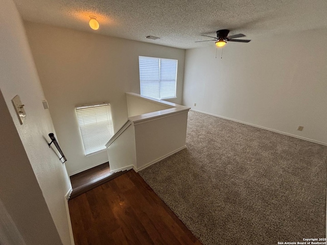 7835 Ruby Mdw, San Antonio, TX 78251 - spare room featuring a textured ceiling, a ceiling fan, baseboards, and wood finished floors