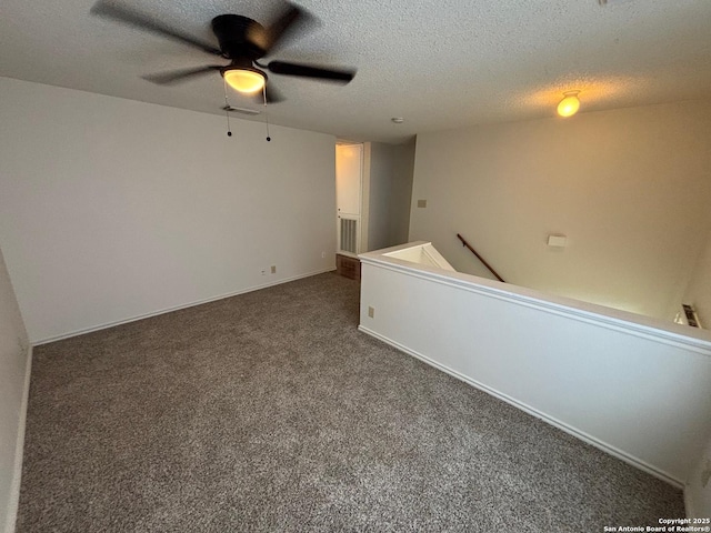 7835 Ruby Mdw, San Antonio, TX 78251 - empty room with dark carpet, a ceiling fan, and a textured ceiling