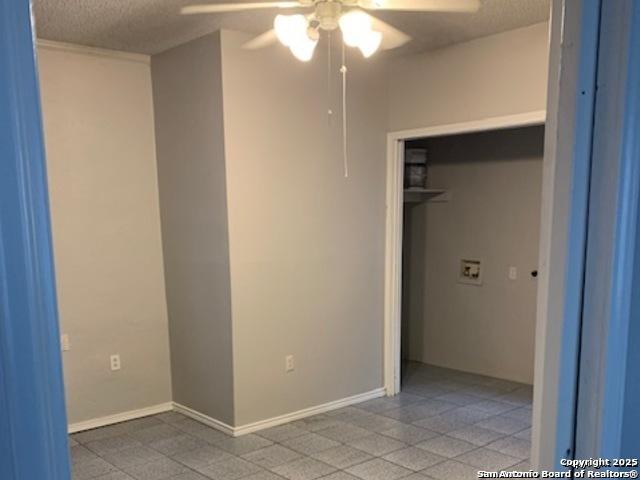 2313 Fresno, San Antonio, TX 78201 - unfurnished bedroom featuring a textured ceiling, a closet, a ceiling fan, and baseboards