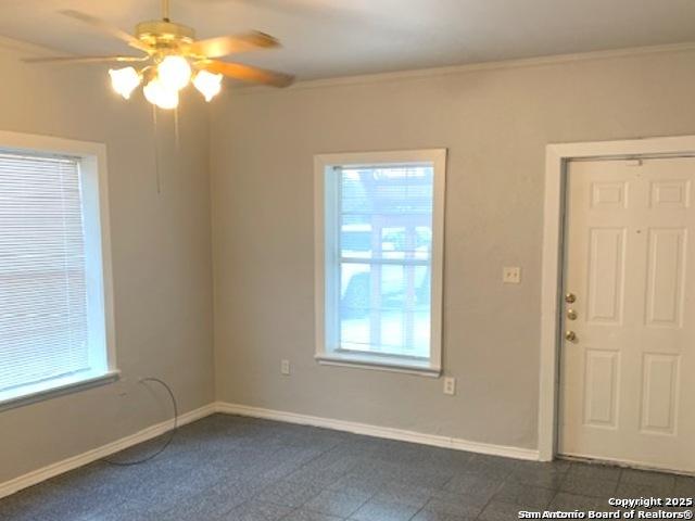 2313 Fresno, San Antonio, TX 78201 - spare room with plenty of natural light, a ceiling fan, baseboards, and crown molding
