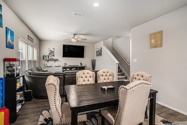 7129 Pisces, Converse, TX 78109 - dining space with ceiling fan, stairway, dark wood-style floors, baseboards, and a textured ceiling