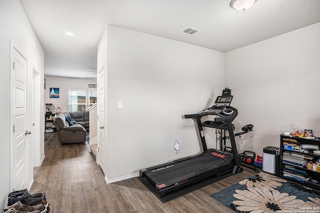 7129 Pisces, Converse, TX 78109 - exercise room featuring wood finished floors and baseboards
