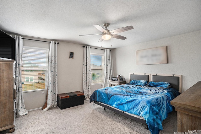 7129 Pisces, Converse, TX 78109 - carpeted bedroom featuring multiple windows, a textured ceiling, a ceiling fan, baseboards, and a textured wall