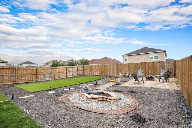 7129 Pisces, Converse, TX 78109 - fenced backyard with a fire pit and a patio area